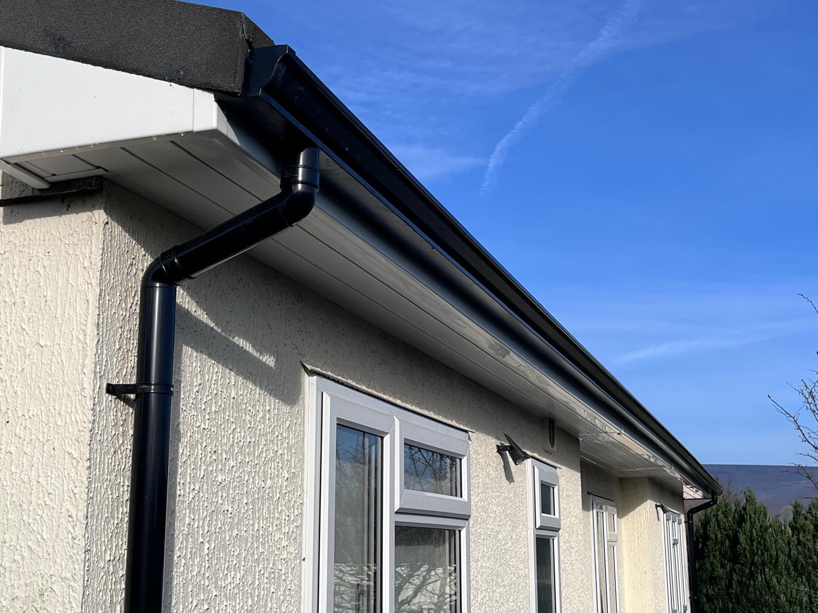 Black seamless guttering on park home